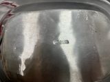 a metal pan with a lid sitting on a table
