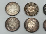 six different types of coins are shown on a white surface