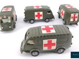 four toy army vehicles with red cross markings on them on a white surface