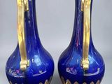pair of blue vases with gold handles on a white background