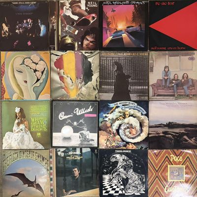 many different album covers on the wall of a room