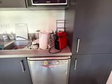 a small kitchen with a microwave, dishwasher, and a dishwasher