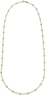 a gold necklace with pearls on a white background