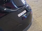 a sticker on the back of a black car