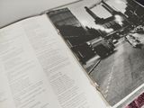 an open book with a black and white photo of a city