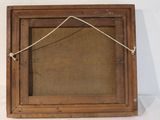 a picture of a wooden frame hanging on a wall