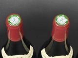 six bottles of wine are lined up in a row on a table