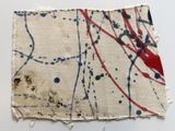 a close up of a piece of fabric with paint splatters on it
