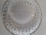 two clear glass plates on a white table