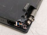 a black laptop with a couple of screws on the side of it