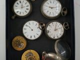 a box with many different types of pocket watches in it