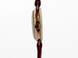 a wooden sculpture of a man holding a knife and fork