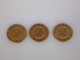 three gold sovereigns, one of which is a sovereign and one of which is a sovereign