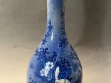 un vase bleu et blanc posé sur une table