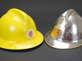 yellow and silver hard hat sitting next to each other on a black surface