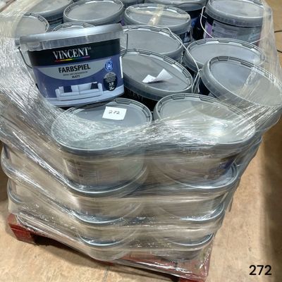 many cans of paint sitting on a pallet in a warehouse