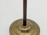 an antique brass candle holder on a white background