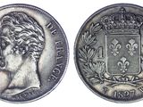 une pièce d'argent surmontée d'une couronne