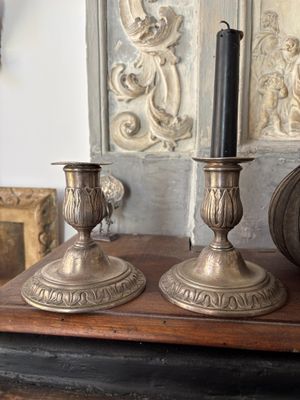 two candles that are sitting on top of a table
