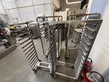 many racks of food that are being prepared in the kitchen