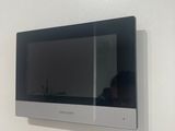 someone is taking a picture of a television mounted on a wall
