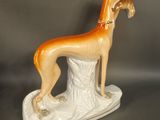 figurine of a greyhound dog on a base on a gray background
