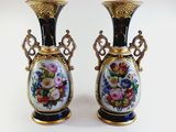 pair of vases decorated with flowers on a white background