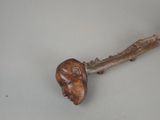 a wooden stick with a face on it on a table