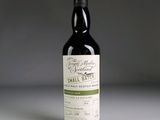 the bottle of small batch wine is sitting on the table