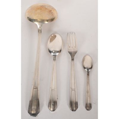 an assortment of silverware including a spoon, fork, and spoon rest