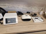 a white microwave sitting on a wooden table next to a black bag