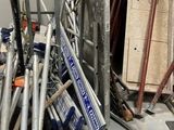 a pile of baseball bats and other baseball equipment in a room