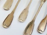 a lot of silver spoons and forks on the table