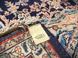 an image of a blue rug with a tag on it