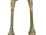 pair of silver plated spoons with ornate designs on them