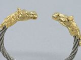 pair of horse head cuff bracelets in 18k yellow gold and sterling
