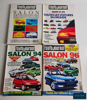 four magazines of different cars on display on a table