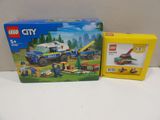 a box of lego city vehicles and a box of construction toys