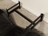 a black leather chair and a black leather chair in a living room