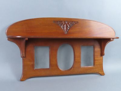 a wooden shelf with a mirror on top of it