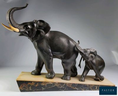 a statue of an elephant and a baby elephant with tusks