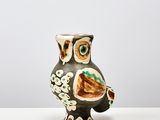 an owl shaped vase sitting on a white table