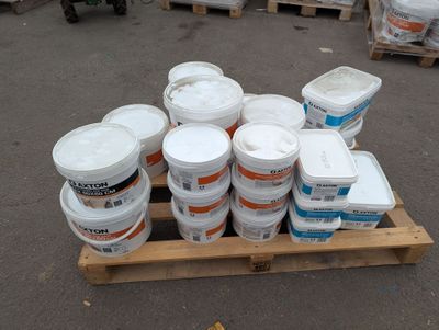 many buckets of paint sitting on a pallet