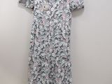 a dress hanging on a hanger next to a white wall