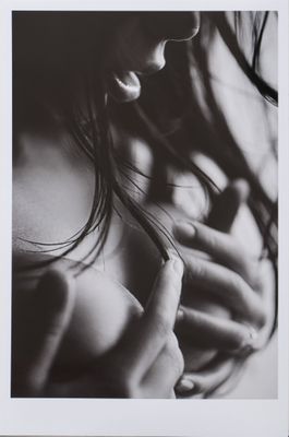 black and white photograph of a woman with her hands on her chest