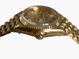a gold watch with a white face on a gold bracelet