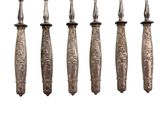 six antique silverware spoons with ornate designs on them