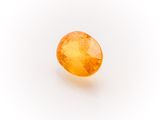 an oval shaped yellow sapphire stone on a white background