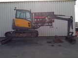 a picture of a construction vehicle parked in front of a building