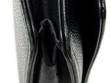 the inside of a black leather purse on a white surface